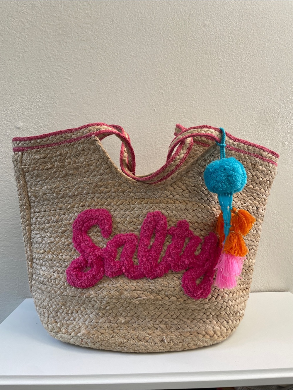 Shiraleah Natural Jute Tote with Bright Pink Script and Multicolor Pom-Poms
